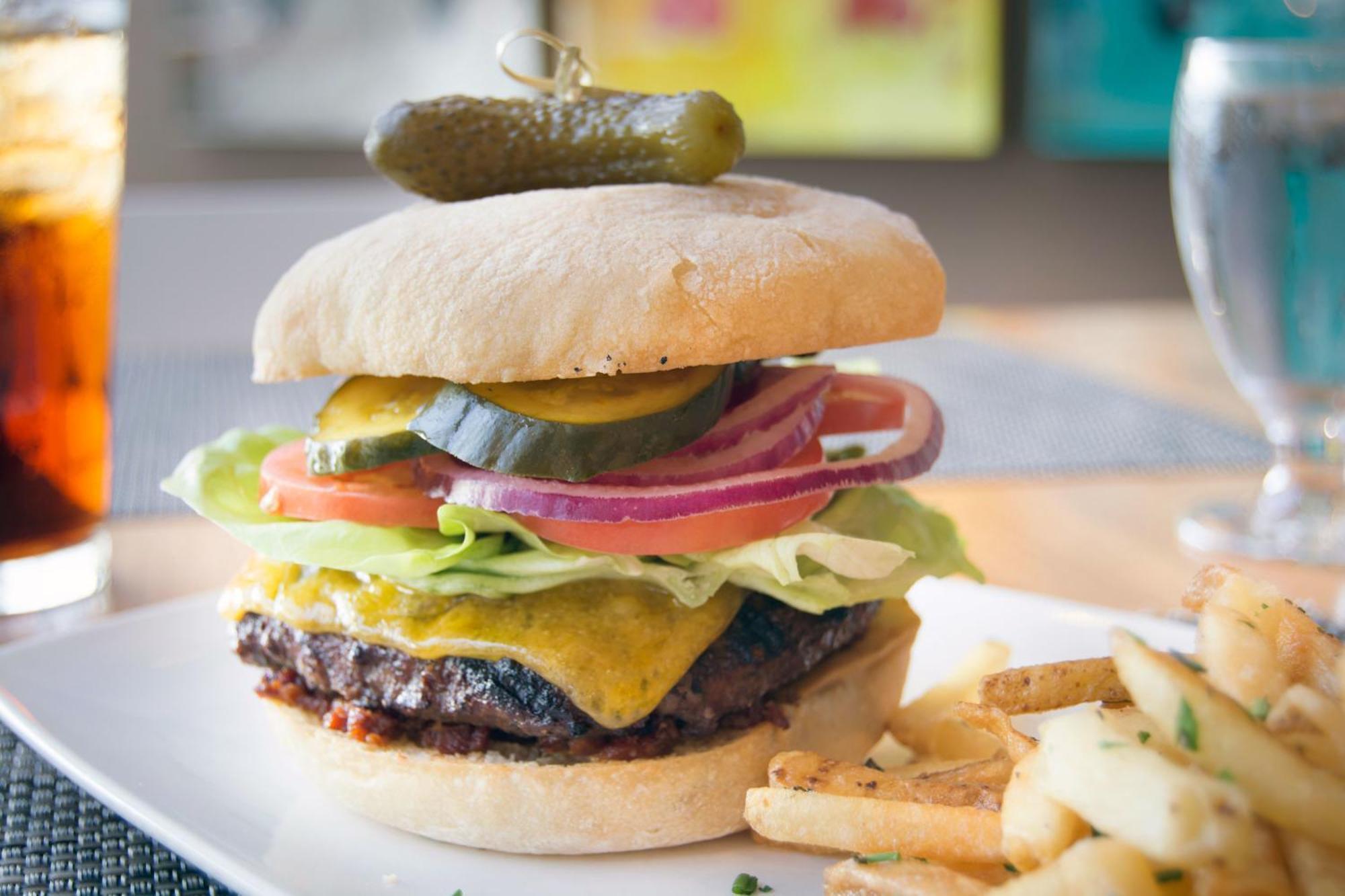 Hotel Murano Tacoma Exterior foto A cheeseburger with lettuce, tomato, onion, and pickle